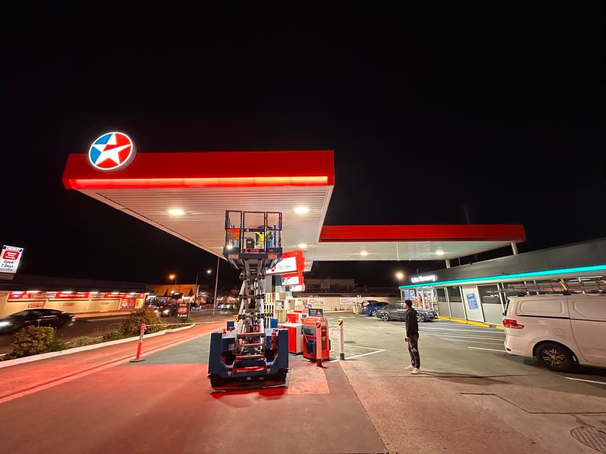 Service station canopy painted overnight from a lift