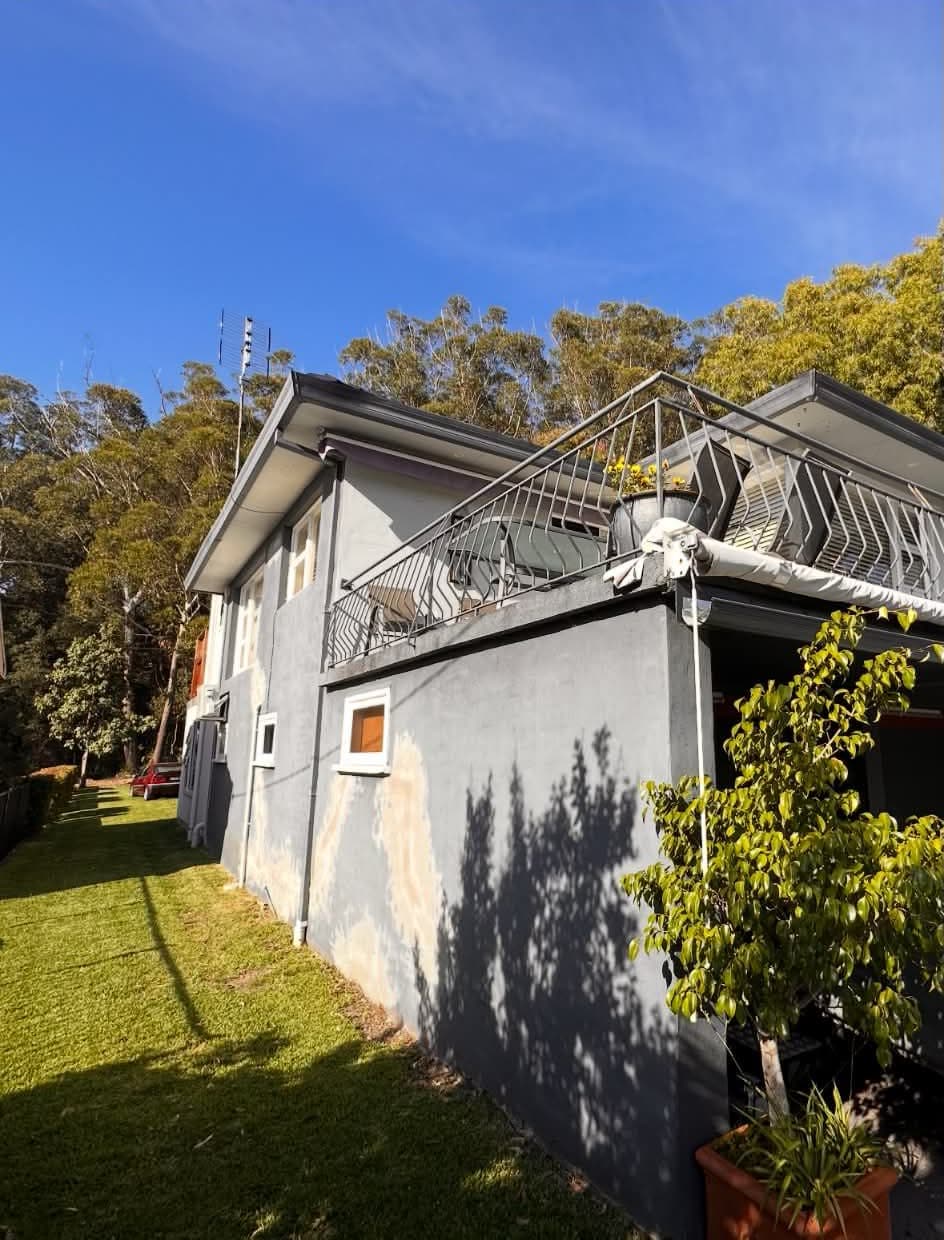 House exterior before repainting, in faded grey