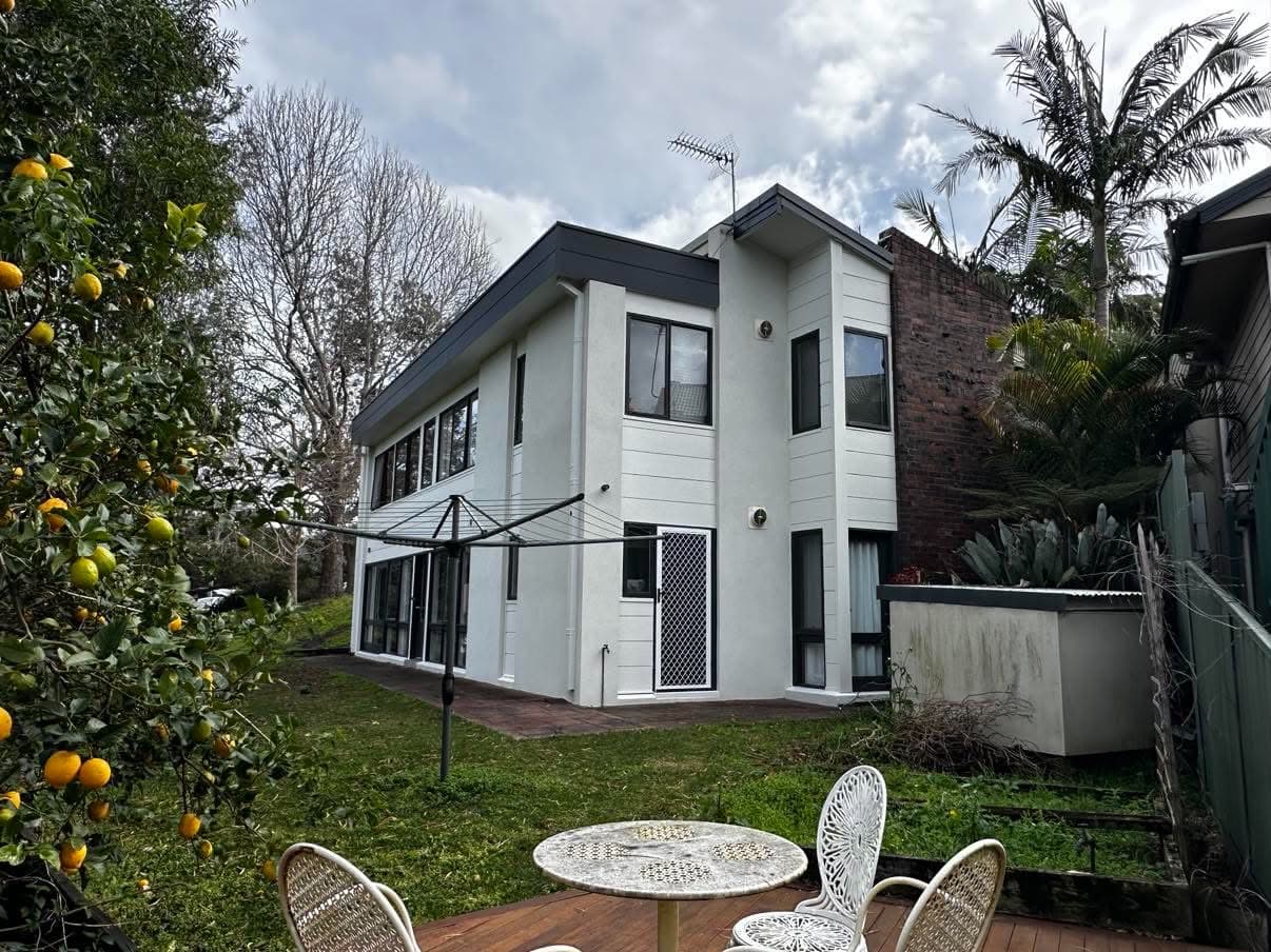 Two-storey home exterior repainted white