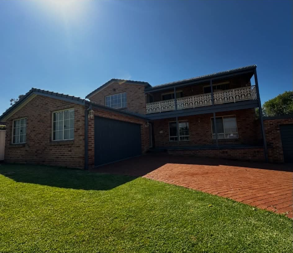 Garage door, gutters, eaves and balcony repainted charcoal
